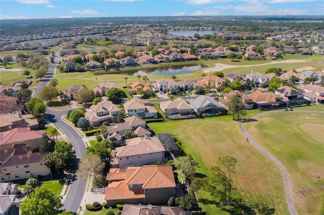 aerial view with a residential view, a water view, and golf course view