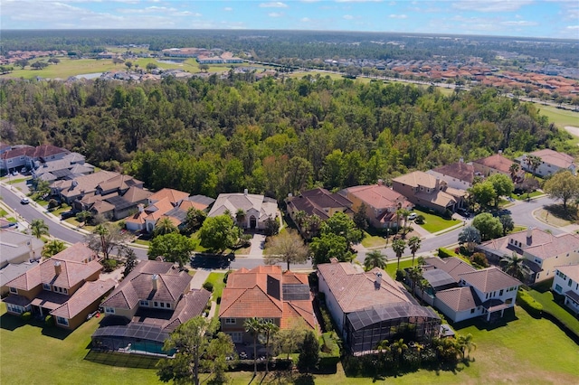 drone / aerial view featuring a residential view and a view of trees