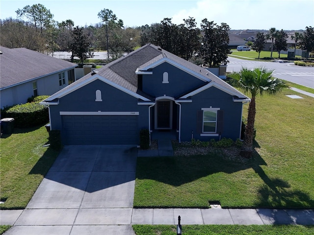 view of front of house with driveway, a front lawn, and an attached garage