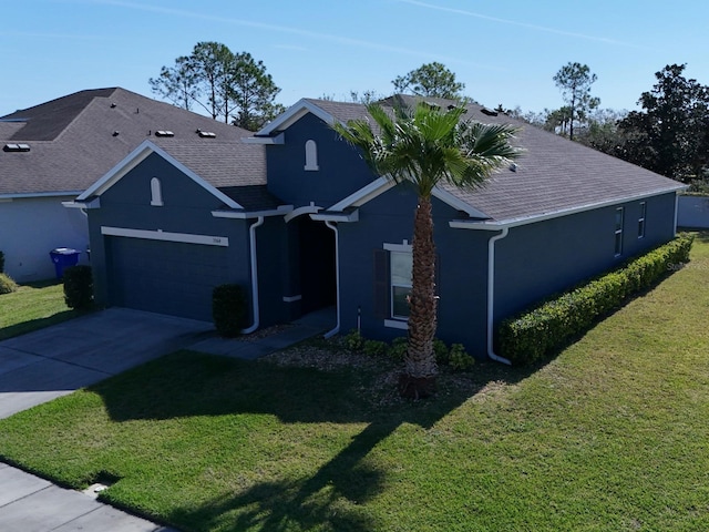 view of front of house featuring concrete driveway, roof with shingles, an attached garage, a front yard, and stucco siding