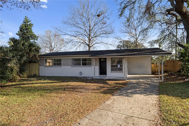 ranch-style home with concrete driveway, brick siding, a front yard, and fence