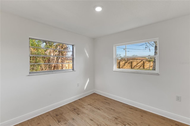 empty room featuring light wood-style flooring and baseboards