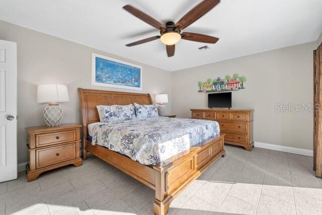 bedroom featuring light tile patterned floors, ceiling fan, visible vents, and baseboards