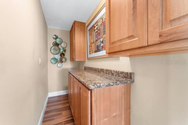 kitchen with baseboards and wood finished floors