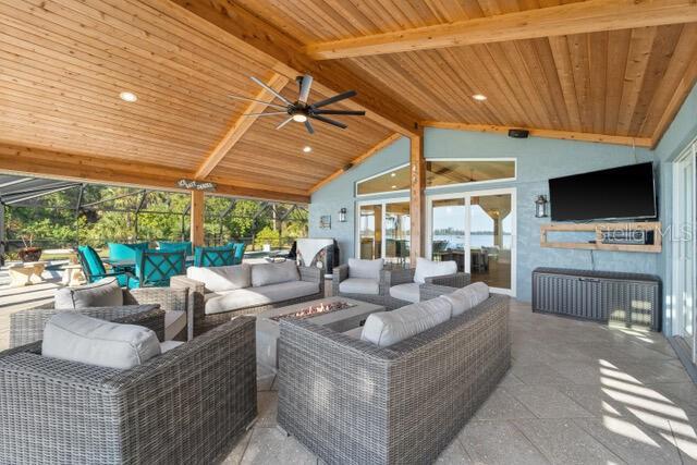 view of patio with an outdoor living space with a fire pit and ceiling fan