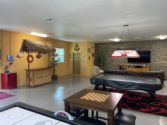 recreation room with visible vents and a textured ceiling