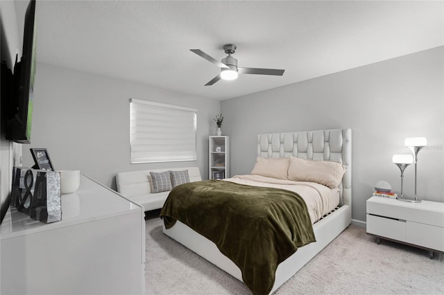 bedroom with ceiling fan and light colored carpet