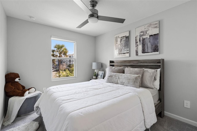 carpeted bedroom with ceiling fan and baseboards