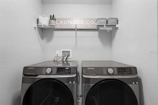 clothes washing area featuring laundry area and washing machine and clothes dryer