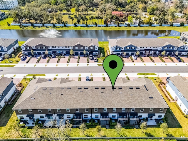 bird's eye view featuring a water view and a residential view