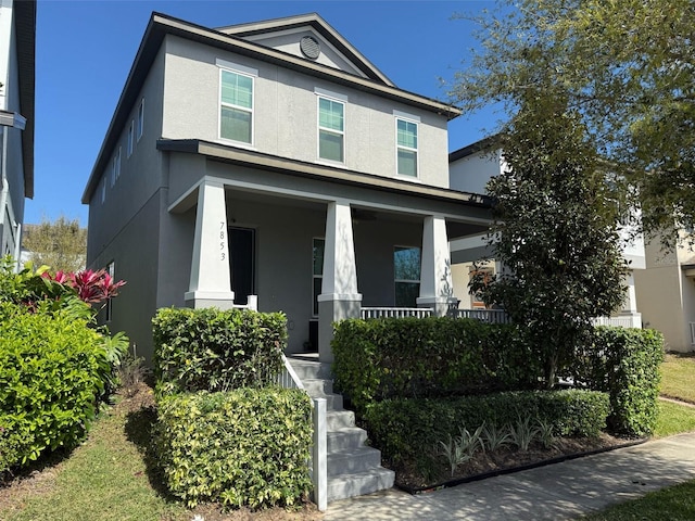 view of front of house featuring covered porch and stucco siding