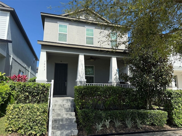 view of front facade with a porch and stucco siding