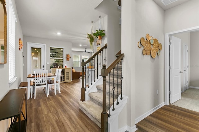 interior space with baseboards, stairway, and wood finished floors