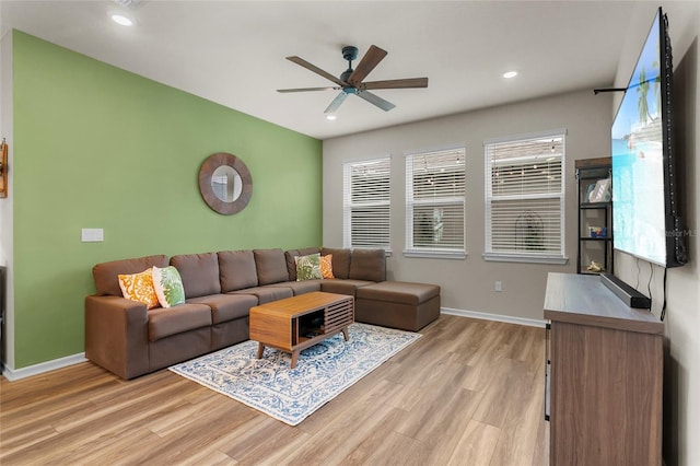 living area featuring baseboards, recessed lighting, a ceiling fan, and light wood-style floors