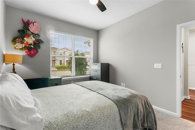 carpeted bedroom featuring ceiling fan and baseboards