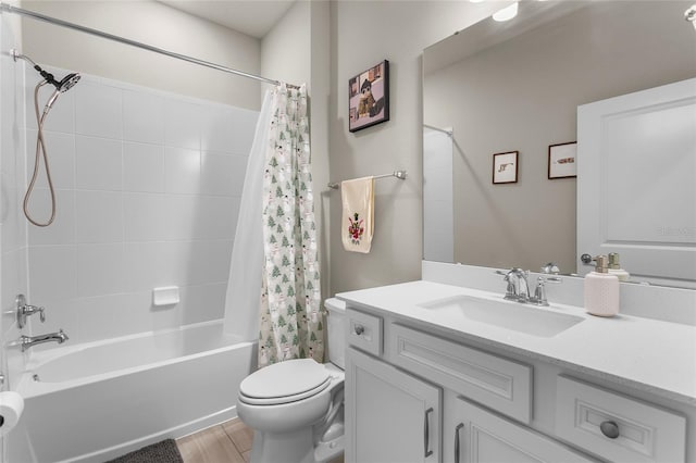 bathroom with shower / bath combo, vanity, and toilet