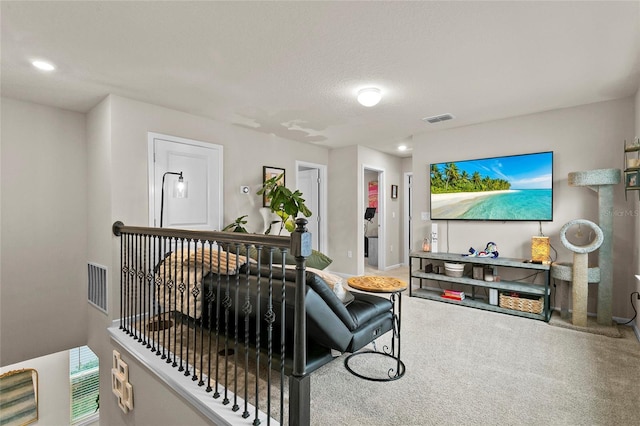 carpeted living area with recessed lighting, visible vents, and a textured ceiling