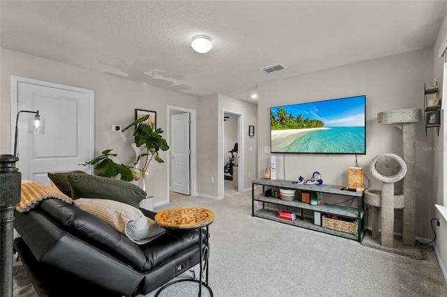 carpeted living room featuring baseboards, visible vents, and a textured ceiling