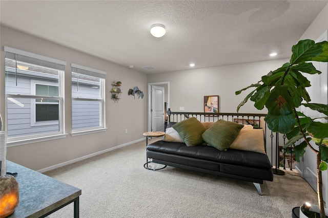 living room with a textured ceiling, carpet floors, recessed lighting, and baseboards