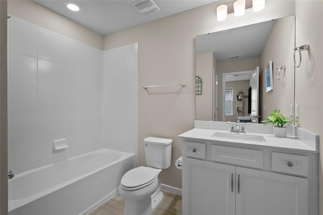 full bath featuring baseboards, visible vents, toilet, vanity, and shower / bathtub combination