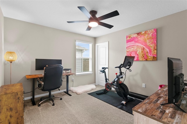 office area featuring carpet flooring, ceiling fan, and baseboards