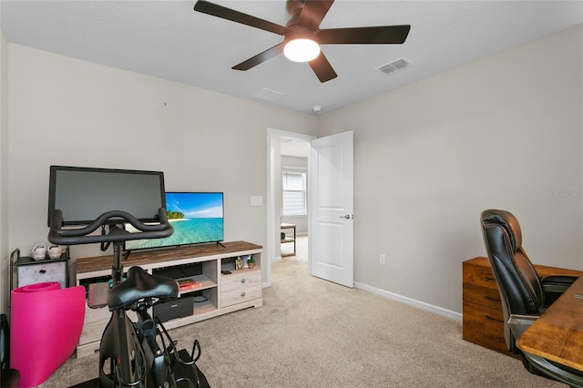 carpeted home office with ceiling fan, visible vents, and baseboards