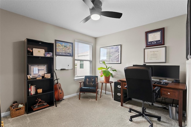 office featuring carpet, a ceiling fan, and baseboards