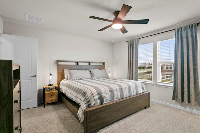 bedroom featuring baseboards, visible vents, ceiling fan, a textured ceiling, and carpet floors