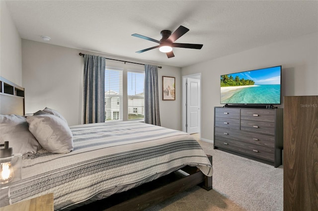 bedroom with a ceiling fan, carpet, a textured ceiling, and baseboards