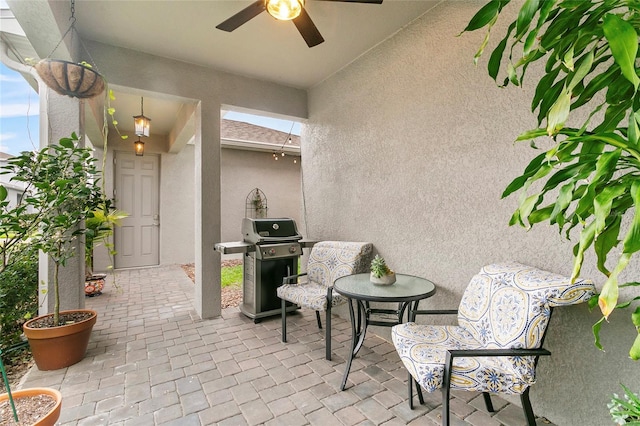 view of patio with ceiling fan and area for grilling