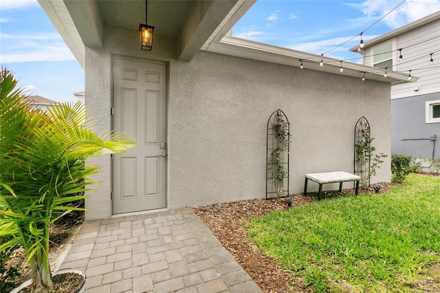 property entrance with stucco siding