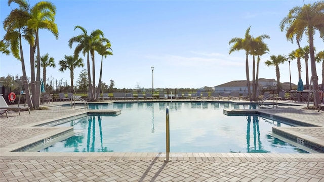 pool with fence and a patio