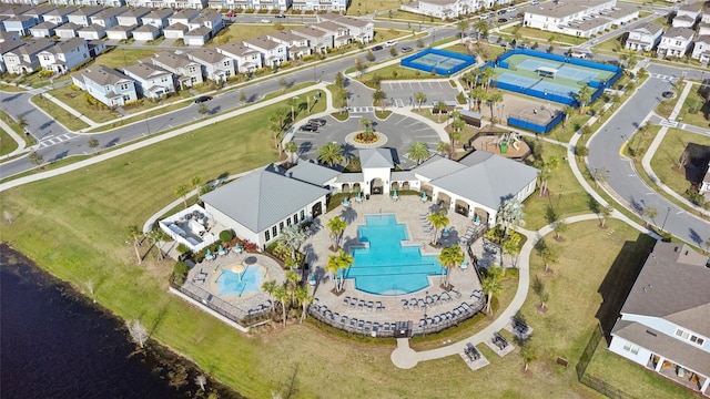 drone / aerial view featuring a water view and a residential view