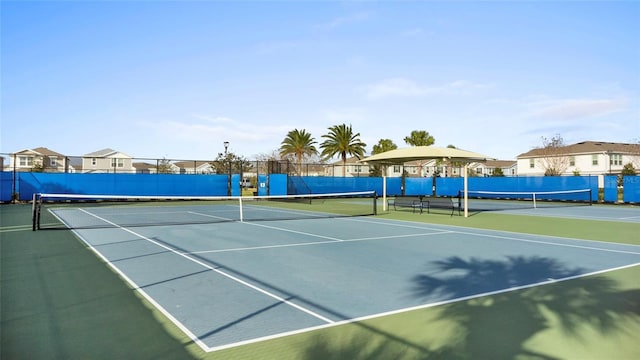 view of sport court featuring fence