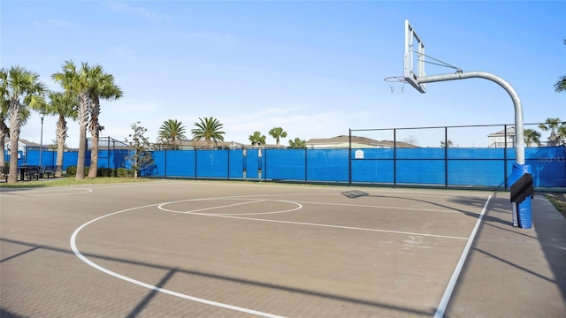 view of basketball court with community basketball court and fence