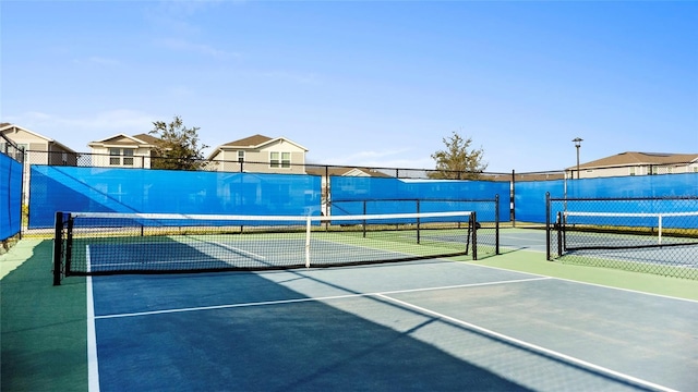 view of sport court with fence