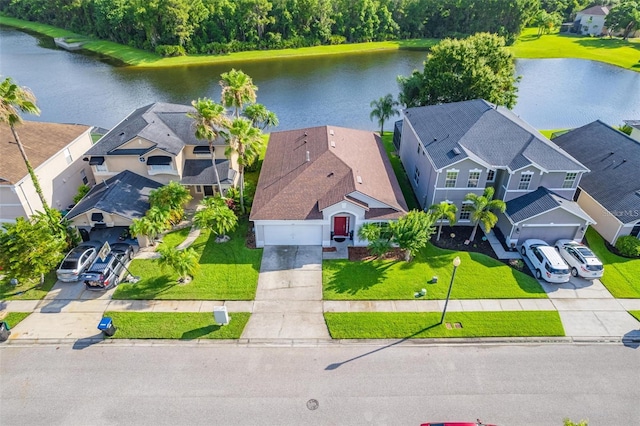 drone / aerial view featuring a water view and a residential view