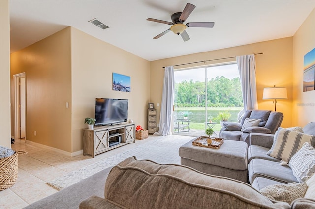 living room with a ceiling fan, visible vents, baseboards, and light tile patterned floors