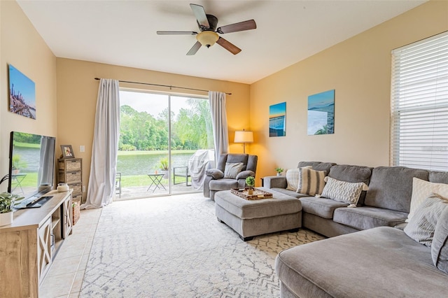 living room featuring ceiling fan and light tile patterned floors