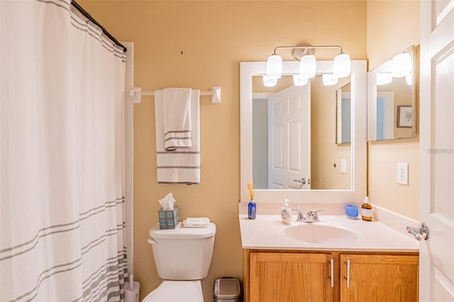 bathroom with toilet, curtained shower, and vanity