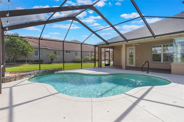 outdoor pool with ceiling fan, a yard, a patio area, and a lanai