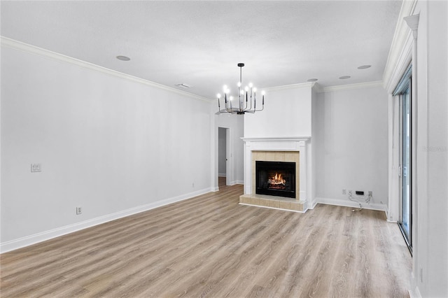 unfurnished living room with baseboards, visible vents, light wood-style flooring, ornamental molding, and a fireplace