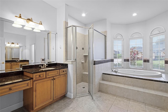 full bath with a stall shower, plenty of natural light, a bath, and tile patterned floors