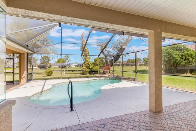 outdoor pool featuring a lanai, a patio area, and a yard