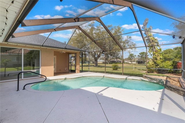 pool featuring a lanai, a ceiling fan, and a patio