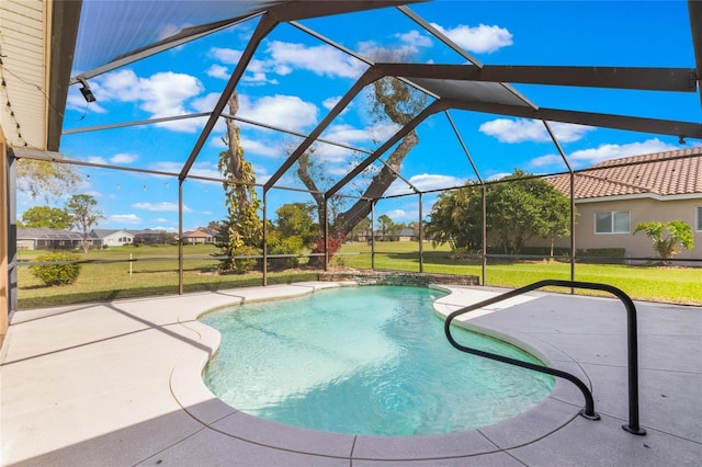 outdoor pool with glass enclosure, a patio area, and a yard