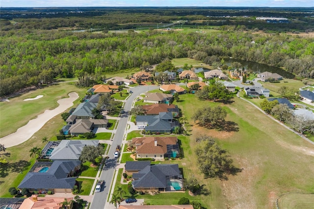 birds eye view of property with a forest view, a residential view, and golf course view