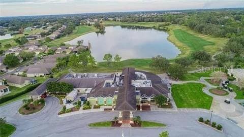 drone / aerial view featuring a residential view and a water view