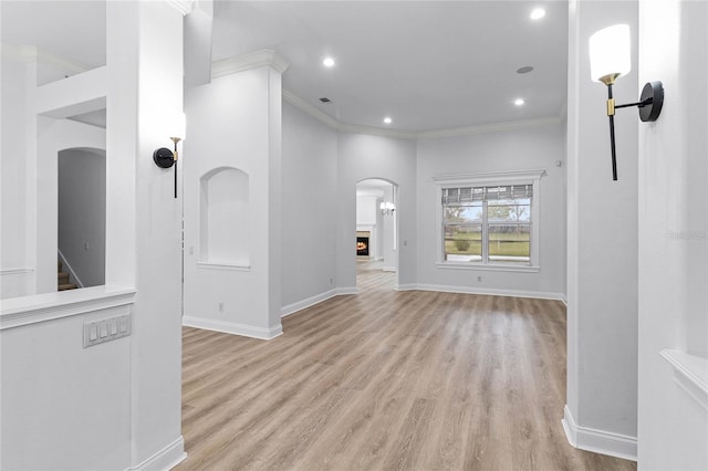 674 Whisper Woods Dr, Lakeland, FL 33813 - interior space with baseboards, light wood-type flooring, a lit fireplace, ornamental molding, and recessed lighting