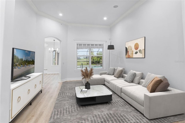 674 Whisper Woods Dr, Lakeland, FL 33813 - living area featuring baseboards, light wood-type flooring, ornamental molding, recessed lighting, and arched walkways